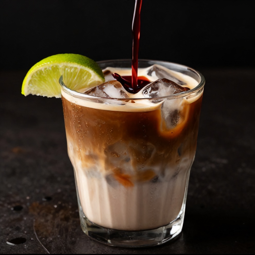 Hibiscus Cardamom Iced Latte poured over ice in a glass