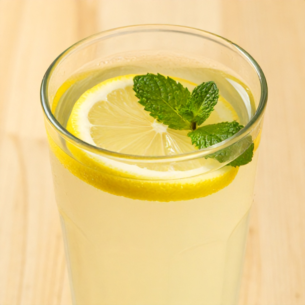 Lemon ginger water with a lemon slice and mint leaf