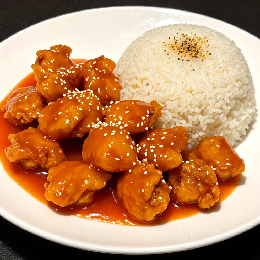 Plated orange chicken with steamed rice